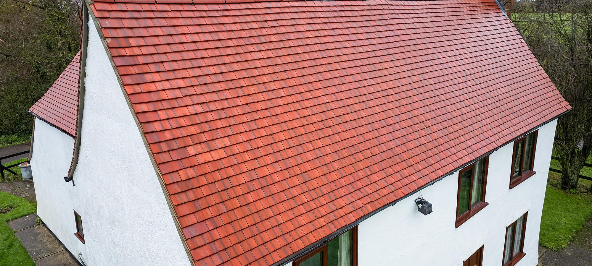 A rendered cottage finished with a new clay tile roof