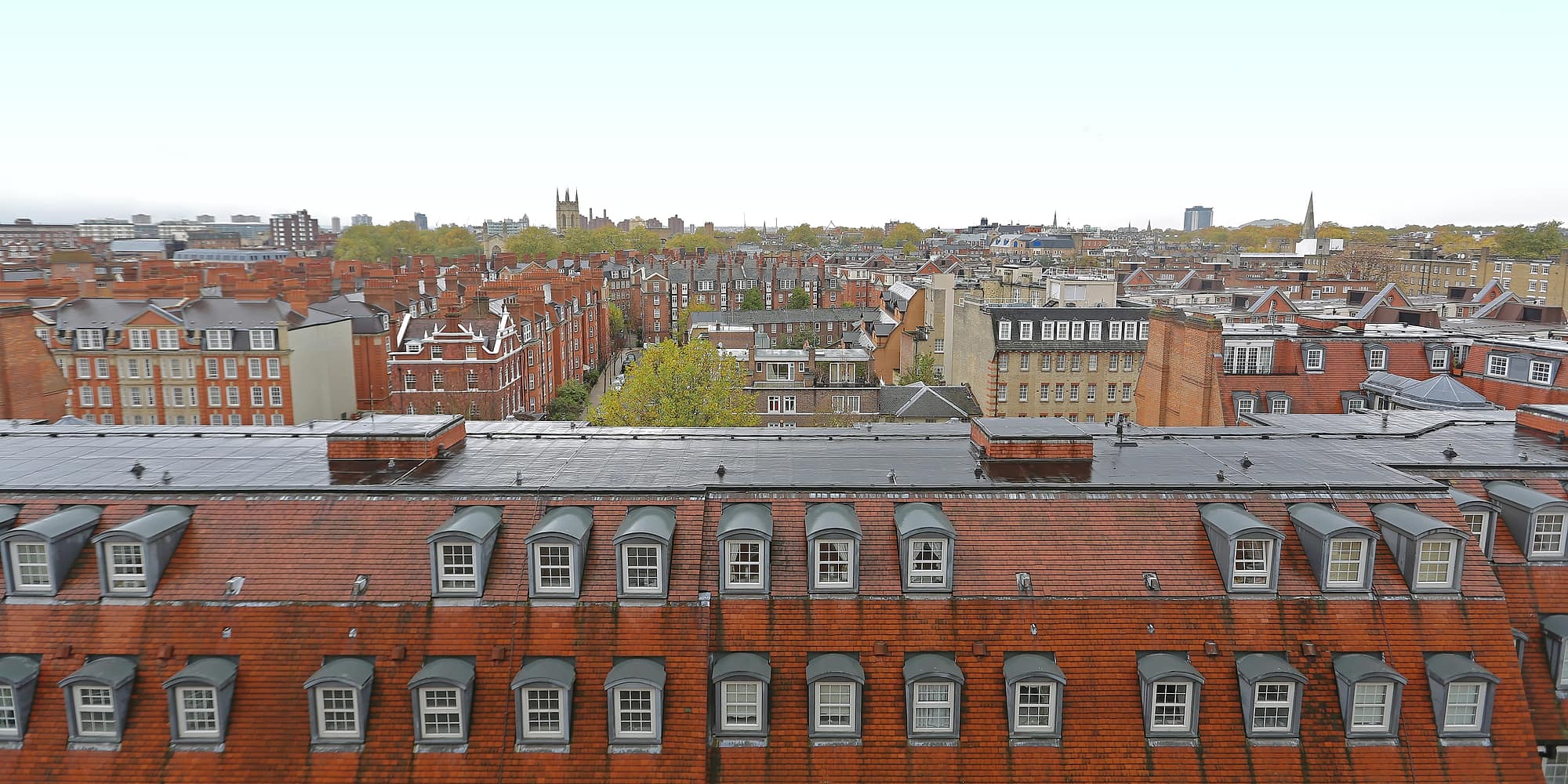 Rooftops and chimney stacks across a city of Victorian terraces