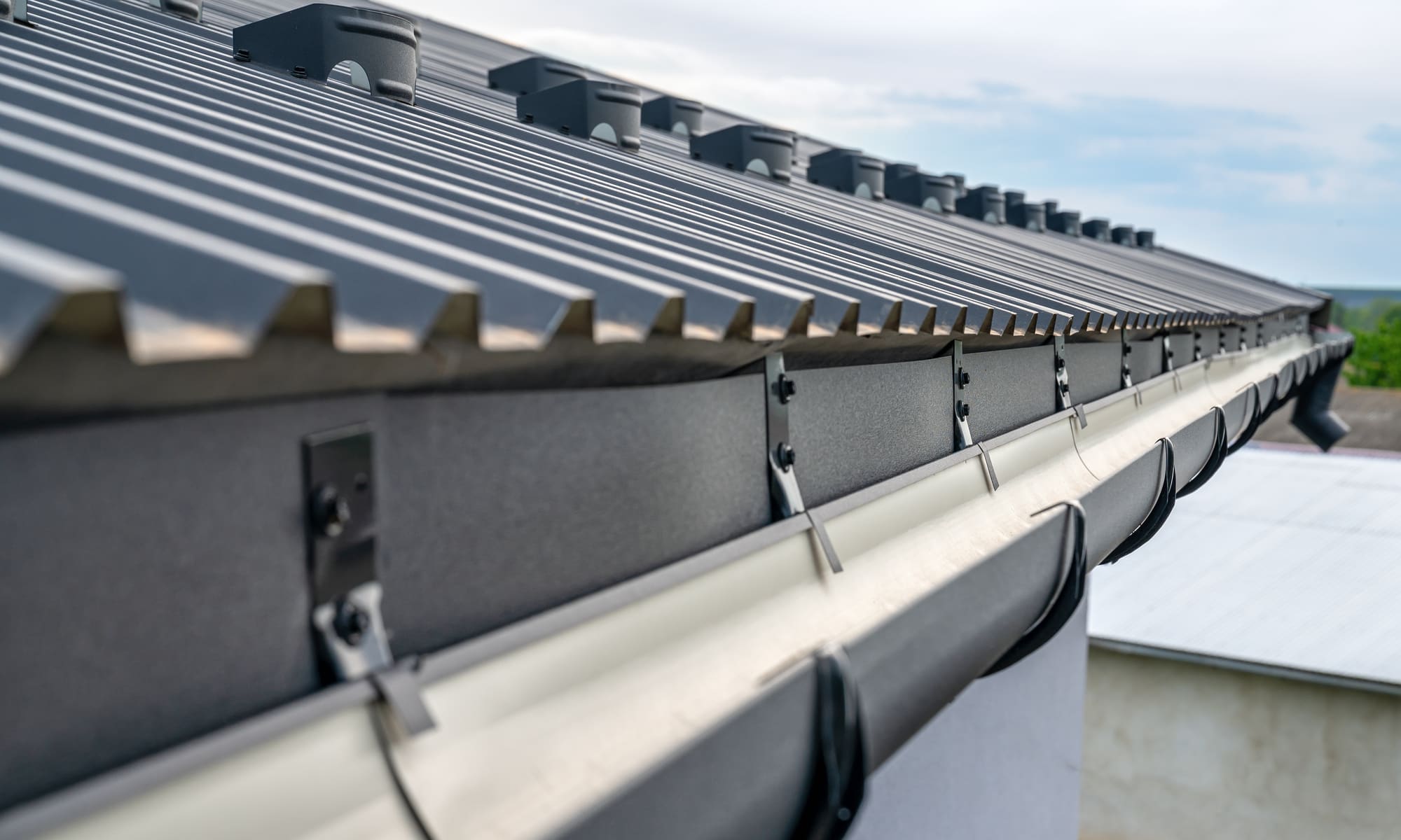 Gutter brackets holding a gutter run along the eaves