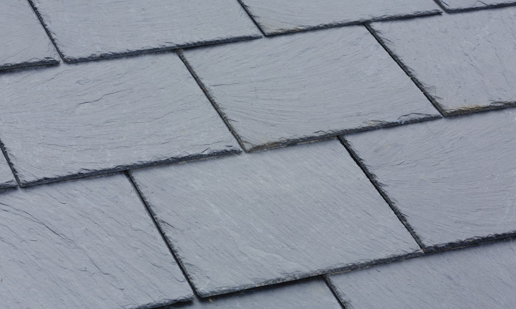 Close up of natural slates laid in even courses